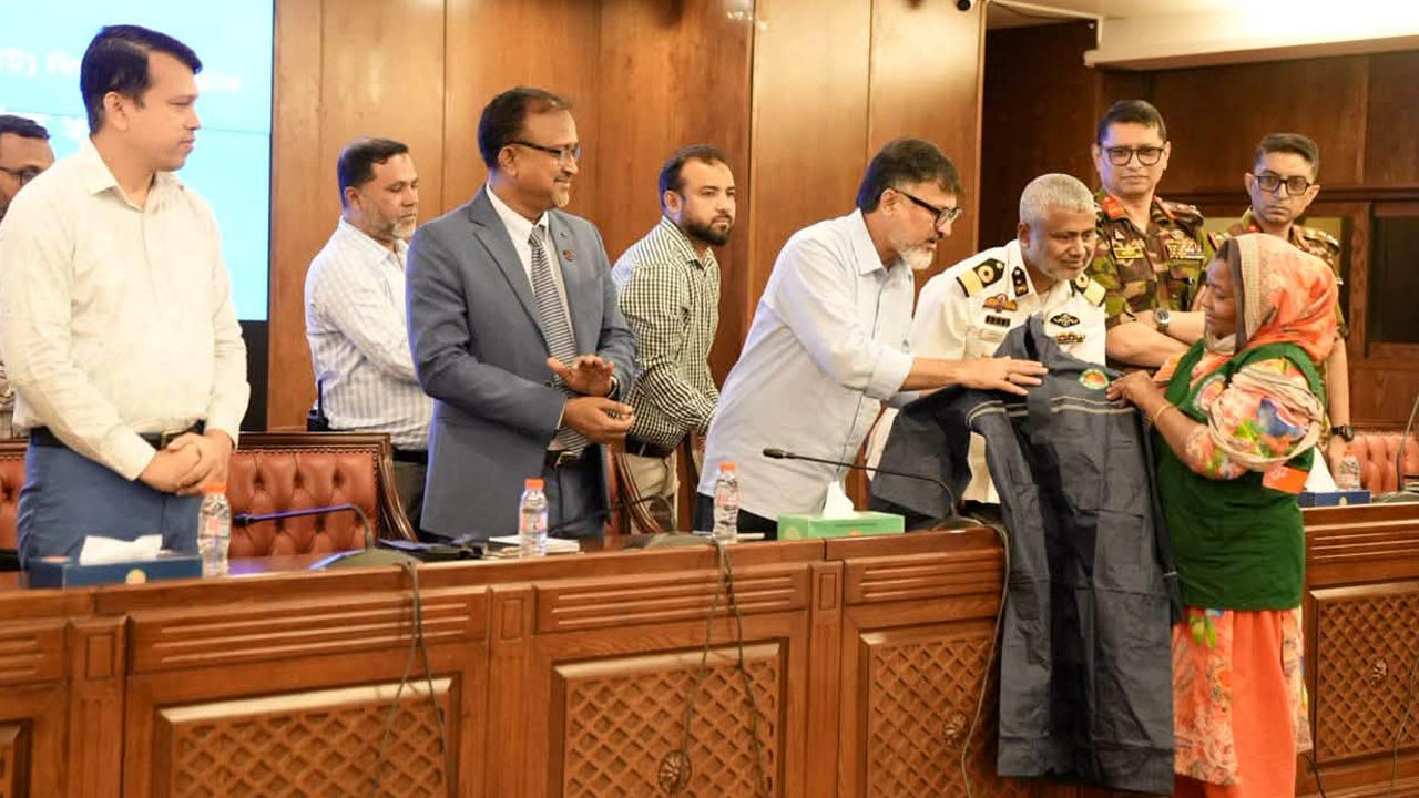 পরিচ্ছন্নতাকর্মীর হাতে রেইনকোট তুলে দিচ্ছেন ডিএনসিসি প্রশাসক মো. শফিকুল ইসলাম খান।